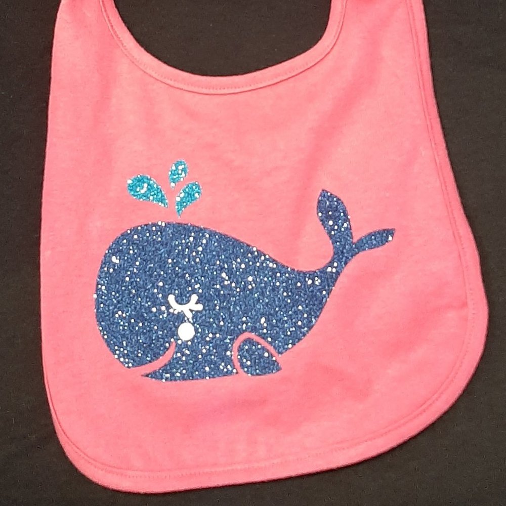 CHILDREN'S BIB.  HOT PINK/BLUE GLITTER FLAKE WHALE